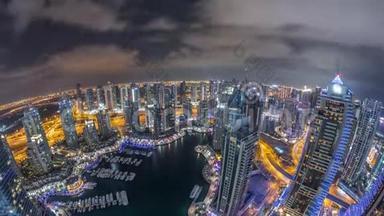 迪拜码头摩天大楼和朱美拉湖塔从最高空中夜晚时间在阿拉伯联合酋长国。